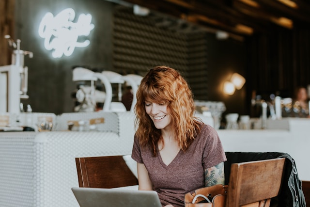 small business owner on laptop in coffee shop