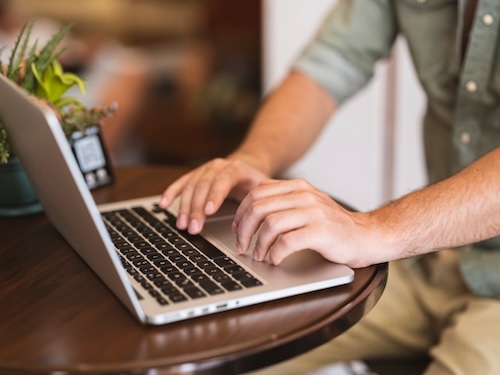 person running wordpress website updates on laptop