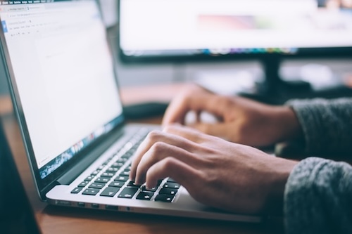 person typing laptop website small