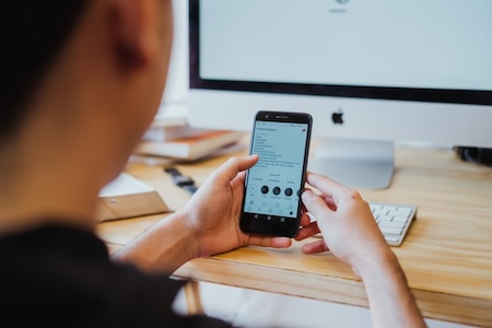 person using website on smartphone and desktop